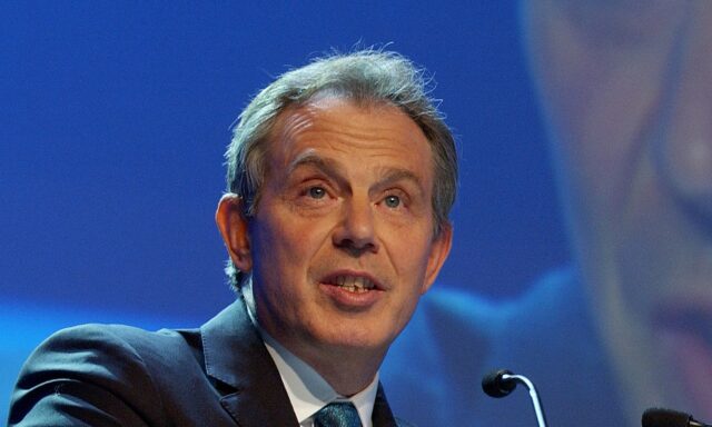 Former Prime Minister Tony Blair gives a speech on stage
