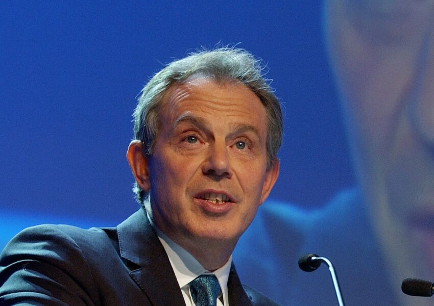 Former Prime Minister Tony Blair gives a speech on stage