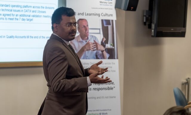 Arun Chidambaram gives a talk to a room of NHS colleagues