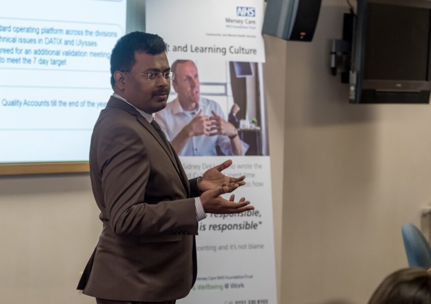 Arun Chidambaram gives a talk to a room of NHS colleagues