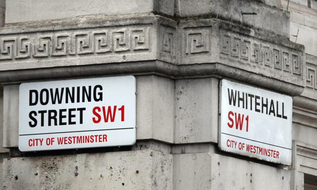 Downing Street and Whitehall signs in Westminster, London, UK.
