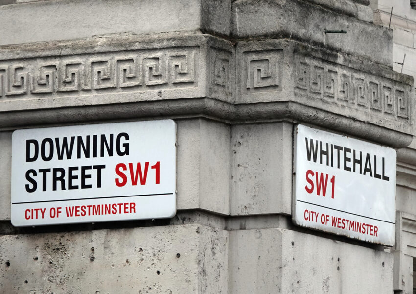 Downing Street and Whitehall signs in Westminster, London, UK.