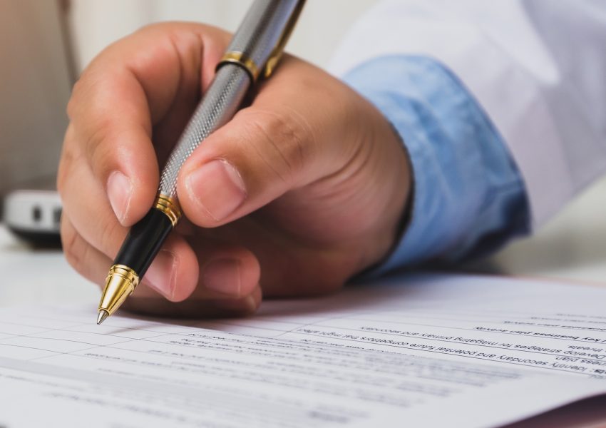 Doctor using a pen to write medical notes