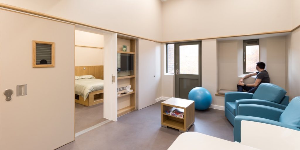 Modern mental health inpatient suite with comfortable seating, personal space and flexible living areas designed to support recovery.