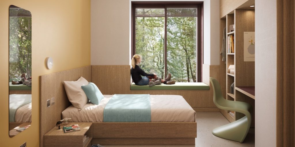 Modern mental health inpatient bedroom with natural light, calming colours and views of trees to support privacy, dignity and recovery.