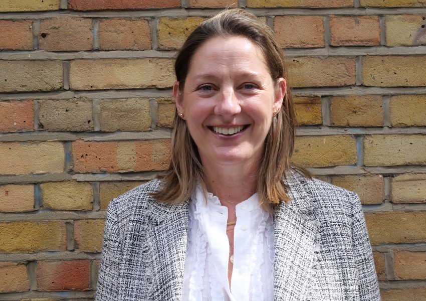 Dr Debbie Martin, mental health law lead within the Thalamos Responsible Innovation Group, photographed against a brick wall.