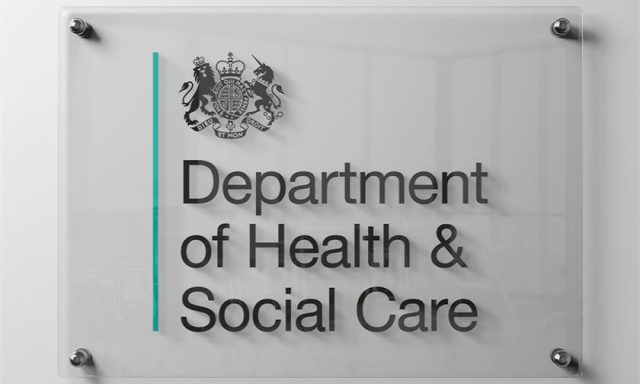 Department of Health & Social Care sign displayed outside a government building.